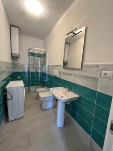 y baño con lavabo, aseo y espejo. en Affittimoderni La Maddalena - MADA25 en La Maddalena