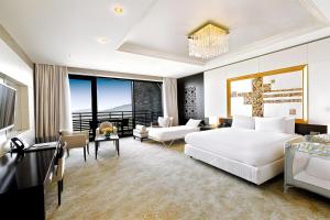 a bedroom with a large bed and a living room at Shahdag Hotel & Spa in Shahdag