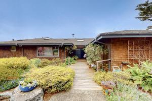 a house with a wooden walkway in front of it at Windrose in Fort Bragg +50 photos