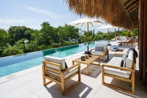 an outdoor patio with chairs and a swimming pool at Casa Letty in Playa Blanca
