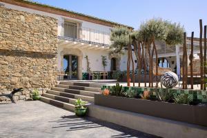 a stone building with stairs and plants in a courtyard at Hotel Mas Lazuli in Pau