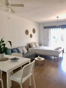 a living room with a couch and a table at Siriana Suites 101, 001 in Benalmádena