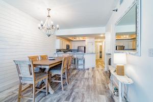 a dining room and kitchen with a table and chairs at Harbor Cove #111 in Orange Beach