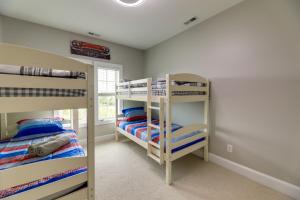 a bedroom with two bunk beds and a window at Harkers Island Vacation Rental with Pool Table! in Harkers Island