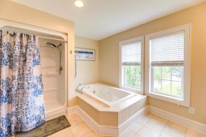 a bathroom with a tub and a window at Harkers Island Vacation Rental with Pool Table! in Harkers Island +21 photos