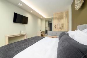 Ένα ή περισσότερα κρεβάτια σε δωμάτιο στο Nicolas Grand Suites, Adults Only