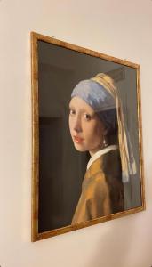 a painting of a woman wearing a head scarf at La casa di Michelle in Foggia +37 photos