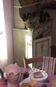 a table with a plate of food on a table at Tenuta Agriturismo IL RISVEGLIO in Imperia