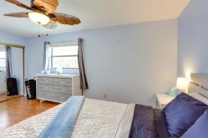 a bedroom with a bed and a dresser and a window at Idyllic Fort Pierce Retreat - Walk to Beach! in Fort Pierce