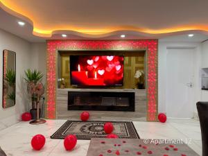 a living room with a fireplace and a tv at Mansa Apartments in Bradford