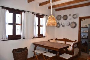a dining room with a wooden table and chairs at MOM'S RETREAT in Siána