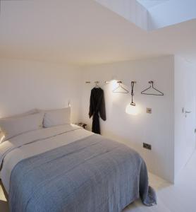 - une chambre avec un lit et deux lumières sur le mur dans l'établissement Eastside - Architect designed retreat with wood-fired sauna, à Penicuik