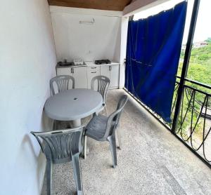 a small balcony with a table and chairs and a kitchen at emily in Sarpi