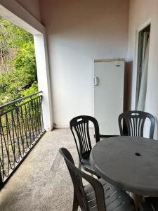 a table and chairs on a balcony with a door at emily in Sarpi