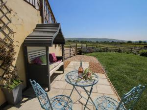 a black gazebo with a table and chairs at Stable Cottage in Bishops Castle