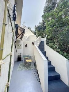 a staircase leading up to a house with a table at T2 entre Mer et Montagnes in Porto-Vecchio +4 photos