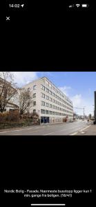 two pictures of a large white building on a street at MK8 Apartment in Bergen