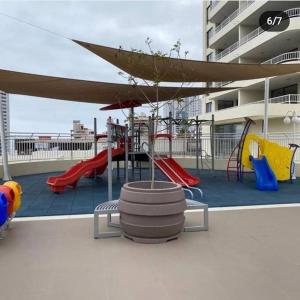 a playground with a slide and slides at Cómodo y Nuevo Depto. Amoblado in Iquique