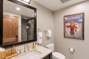 a bathroom with a movie poster on the wall at Edgemont 2504 - Luxury Ski-in Ski-out Condo in Steamboat Springs