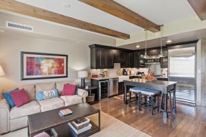 a living room with a couch and a table at Edgemont 2504 - Luxury Ski-in Ski-out Condo in Steamboat Springs