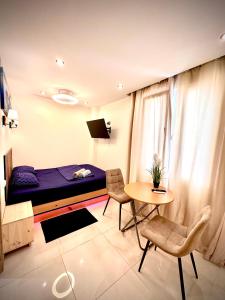 a bedroom with a bed and a table and chairs at Studio El Grao in Grao de Castellón