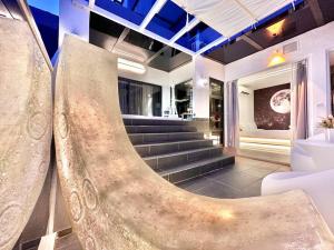 a lobby with a staircase and a stair case at MWHolidayA2713PrivateJacuzzi@SeaVilla in Melaka