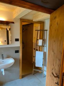 a bathroom with a sink and a mirror and a ladder at Le Camere di Marietta in Rovere Veronese
