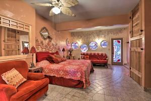 a bedroom with a bed and a couch and chairs at Exotic Home with Patio and Grill Walk to Canyon Lake! in Canyon Lake