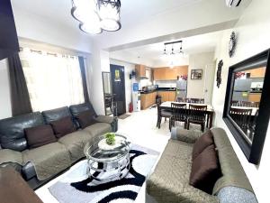 sala de estar con sofá y mesa en Spacious and cozy for families, en Davao City