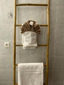 a towel rack with towels on it in a bathroom at Dabia Apartments in Mirina +21 photos