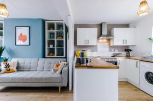 a living room with a couch in a kitchen at Stylish 2-bed home in Chester City-Centre by 53 Degrees Property, ideal for Couples & Small groups, Great Location - Sleeps 5 in Chester