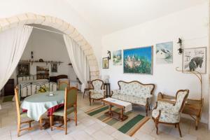 a living room with a table and chairs at Masseria Pozzo Tre Pile in Martina Franca