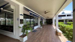 a building with a porch with potted plants on it at Island Escape, Marina Paradise & Beach Adventures in Saint Martin