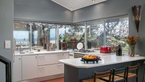 a kitchen with a counter with a bowl of fruit on it at Noordhoek Bliss Beach House in Cape Town