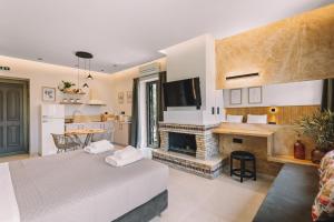 a living room with a bed and a fireplace at Bonos apartments in Stoupa