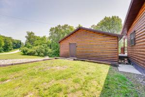 a wooden house with a yard in front of it at Charming Cabin Near Roaring River State Park! in Cassville