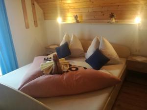 a bedroom with a bed made out of pillows at Privát RIA in Pavlova Ves