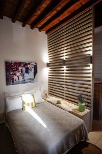 een slaapkamer met een groot bed en een groot raam bij Chrissa's loft in Patmos