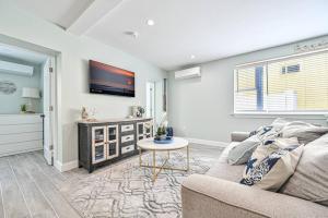 a living room with a couch and a tv at 318 E Youngs Ave Unit 1 Seaside Serenity Salty Shore Retreat in Wildwood