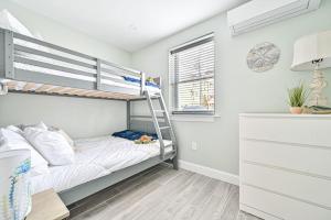 a bedroom with a bunk bed and a ladder at 318 E Youngs Ave Unit 1 Seaside Serenity Salty Shore Retreat in Wildwood