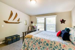 a bedroom with a bed and a window at Ocean Shores Retreat with Porch and Canal Views! in Ocean Shores