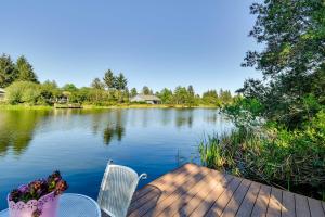 a view of a lake with two chairs on a dock at Ocean Shores Retreat with Porch and Canal Views! in Ocean Shores