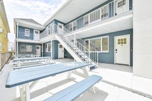 a house with a blue bench in front of it at 318 E Youngs Ave Unit 3 Serene Seaside Retreat Salty Shore in Wildwood