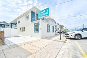 a car parked in front of a house with a ally store sign at 318 E Youngs Ave Unit 4 Charming Salty Shore Retreat Your Perfect Getaway in Wildwood