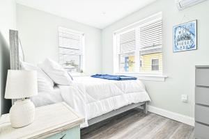 a white bedroom with a bed and a window at 318 E Youngs Ave Unit 5 Salty Shore Oasis Spectacular Retreat in Wildwood