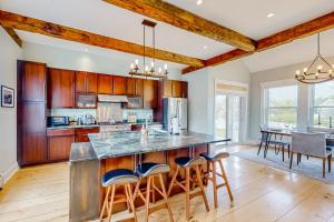 a kitchen with wooden cabinets and a large island with bar stools at The Retreat - Suite #2 in Waterbury