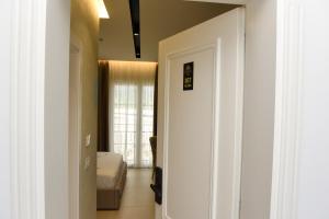 pasillo con una habitación con cama y ventana en Hotel Royal en Shkodër