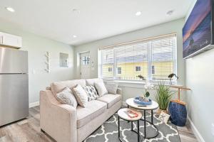 a living room with a couch and a refrigerator at 318 E Youngs Ave Unit 6 Salty Shore Serenity Beachside Bliss in Wildwood +9 photos