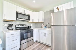 a kitchen with white cabinets and a stainless steel refrigerator at 318 E Youngs Ave Unit 6 Salty Shore Serenity Beachside Bliss in Wildwood