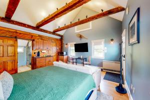 a living room with a large bed and a kitchen at The Lodge - Suite #3 in Waterbury